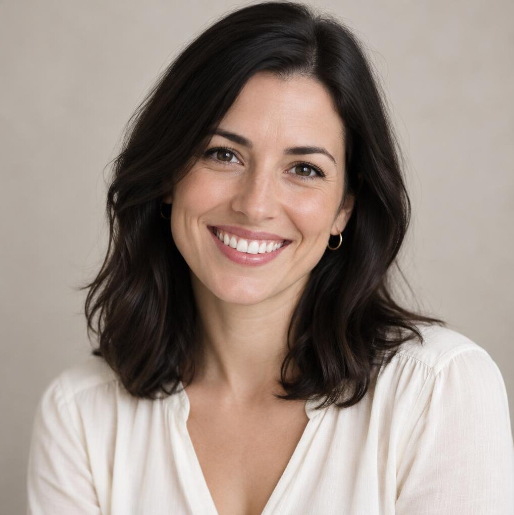 Portrait of a woman with dark hair and a warm smile