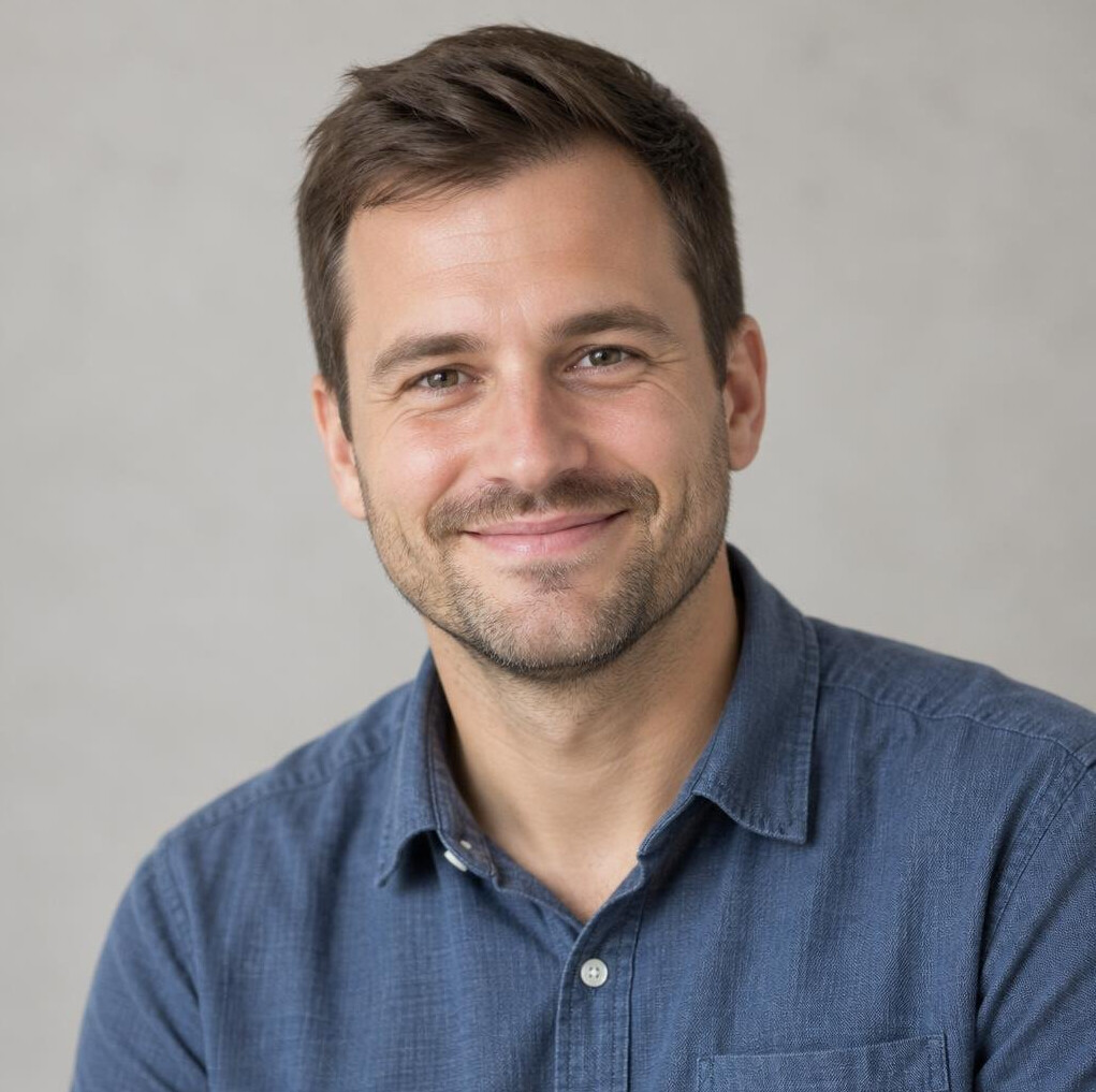 Portrait of a smiling man with short brown hair in a casual shirt