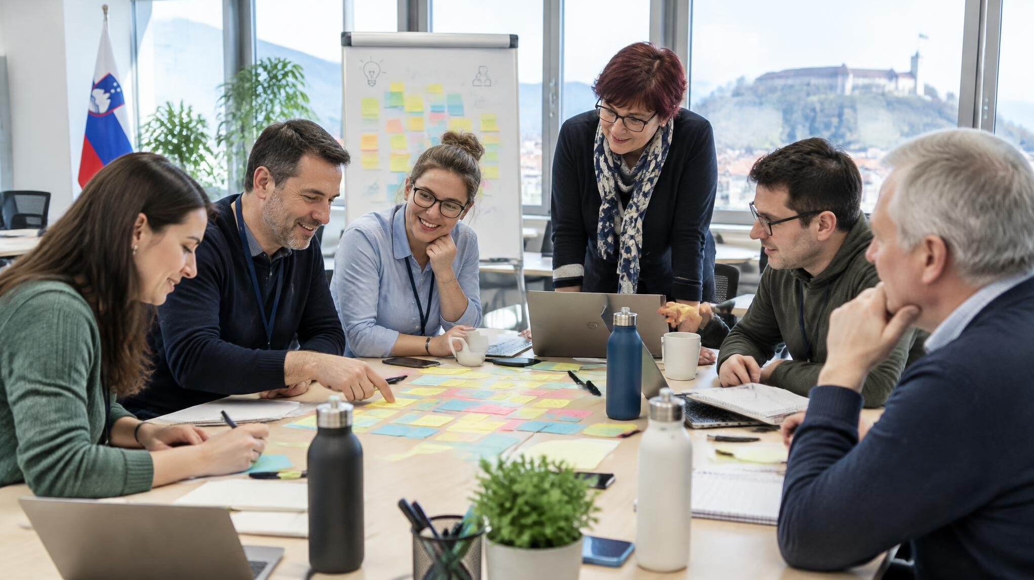 Group of colleagues collaborating around a table in a workshop